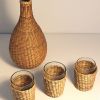 Bouteille et 3 verres entourés de rotin