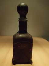 ancienne bouteille à cognac recouverte de cuir