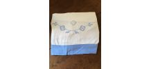 Drap blanc à la bordure bleue lavande.