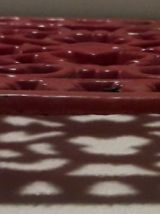 dessous de plat en fonte rouge