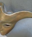 Masque décoratif en terre cuite patinée.