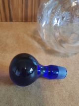 carafe verre transparent et bouchon bleu