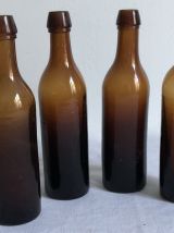 Ensemble de 4 anciennes bouteilles ambrées