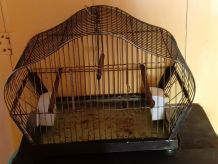 Cage à oiseaux en métal avec mangeoires en porcelaine.