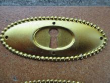 Entree de serrure ancienne ovale dorée pour meuble